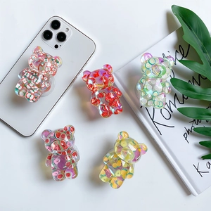 Transparent bear phone grip with fruit motifs on white desk with aesthetic props