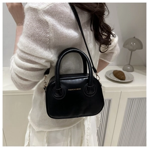 Close-up of black PU leather Boston bag with gold lettering and detachable shoulder strap