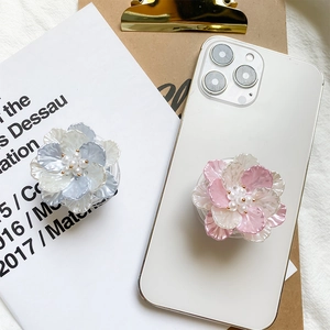 Detailed macro of flower phone grip with pearl center and iridescent gradient petals