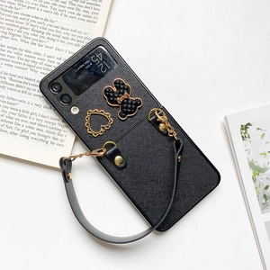 Close-up of black crossbody phone case for Galaxy Z Flip with heart and bear charms