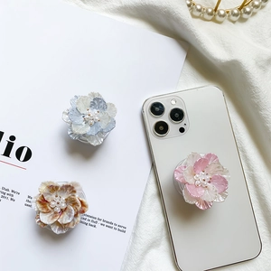 Detailed view of floral phone sockets with pearlescent petals and faux pearl centers