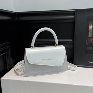 Minimalist square crossbody bag in light blue leather with golden lettering and handle