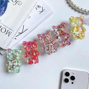 Detail view of five cute bear shaped phone grips with colorful fruit resin patterns