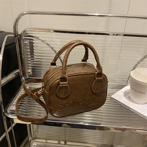 Brown Boston handbag with COIH-2DN embossed letters and adjustable shoulder strap