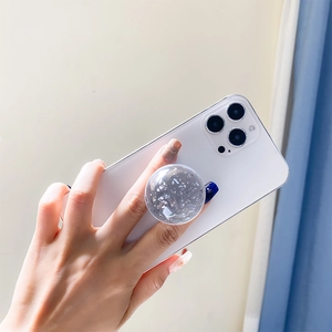 Collapsible clear crystal ball phone socket with silver foil glitters on smartphone