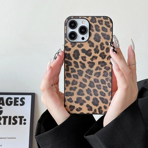 Detail shot of leopard print phone case for iPhone series held by hand in stylish setting