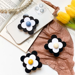 Gros plan détaillé de supports de téléphone en acrylique en forme de fleur sur un smartphone