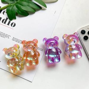 Detail showing four 3D bear phone grips with transparent resin and sparkling glitter flakes