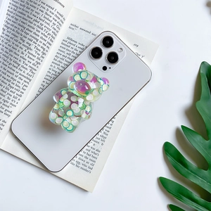 Cute transparent bear phone grip with lime slices on aesthetic book background