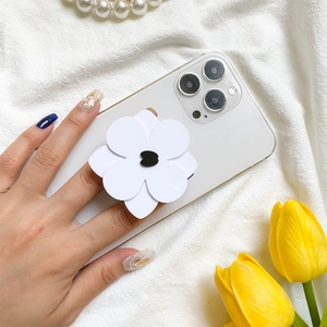 Minimalist black and white flower phone grip stand on a white smartphone back