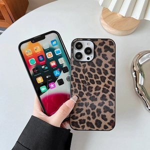 Leopard print protective case for Samsung S21 Ultra and iPhone on a minimalist desk