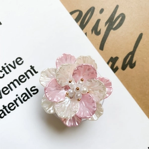 Close-up of pink and white floral phone socket with pearlescent petals and pearl center