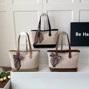 Minimalist canvas tote bags with silk scarves and leather trim in black, khaki, and brown
