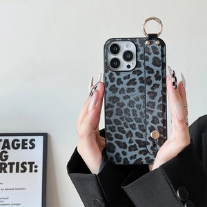 Detail of blue leopard print phone case with adjustable wrist strap and gold ring hook
