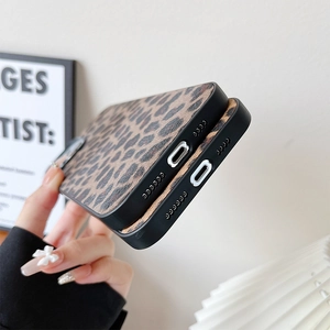 Macro view of leopard print phone case bottom with charging port and speaker cutouts