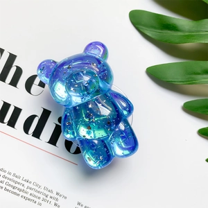 Close-up of bear-shaped phone socket with blue-purple gradient and silver glitter