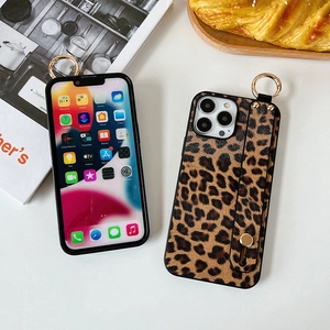 Detailed view of leopard print phone case featuring integrated wrist strap and metal ring