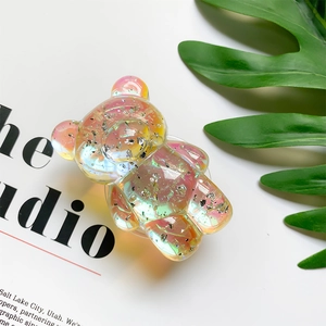 Close-up of iridescent 3D bear phone grip with sparkling silver flakes and resin texture