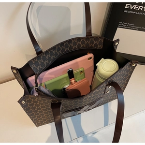 Top view of spacious brown tote bag with M-pattern showing large interior capacity