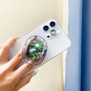 Floral letter phone socket with green leaves and pink berries on a white smartphone