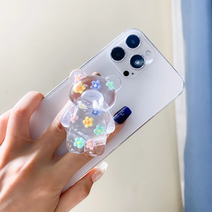 Close-up of a floral bear phone grip holder being held to show clear epoxy texture
