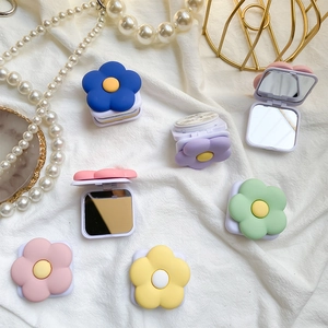 Close-up of floral phone socket stand with built-in makeup mirror and adhesive backing
