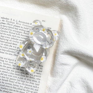 Detailed view of floral bear phone socket on a vintage book page backdrop