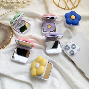 Detail view of colorful floral pop-up mirror sockets in pastel green, pink and purple