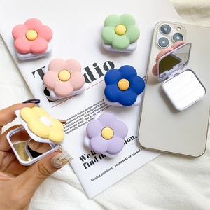 Macro view of colorful floral folding mirror phone socket in vibrant macaron colors