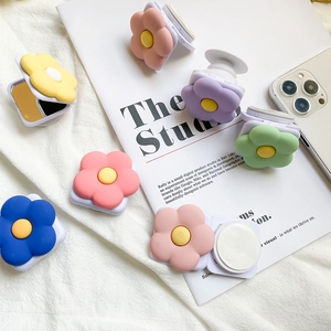Detail of floral pop socket showing expandable grip and integrated vanity mirror