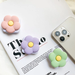 Detailed view of floral phone socket grips in pastel pink, purple and mint green colors