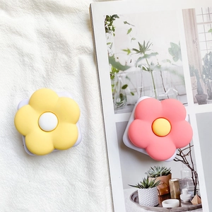 Detail of floral phone socket with pink and yellow petals and retractable mirror base