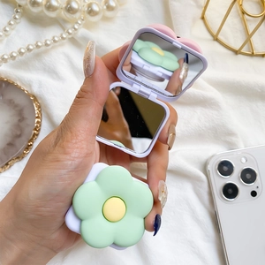 Detail of lavender folding pocket mirror with 3D green flower and dual mirrors