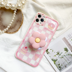 Detail of pink floral phone grip and checkered case with princess patterns on white fabric