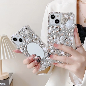 Luxury iPhone case with sparkling rhinestones, makeup mirror, and pearl bunny accents