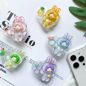 Macro detail of heart-shaped glitter phone grips in pastel resin with cute bunny designs