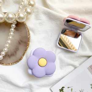 Close-up of portable square flip mirror with 3D macaron flower and dual-sided lenses