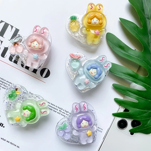 Close-up of heart-shaped glitter phone grips featuring cute rabbit astronaut characters