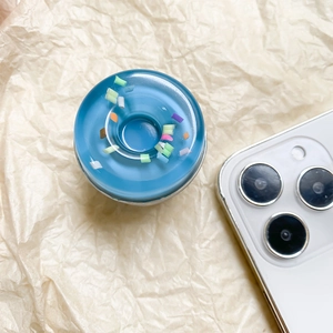 Macro view of blue donut phone socket with colorful flakes on crinkled paper