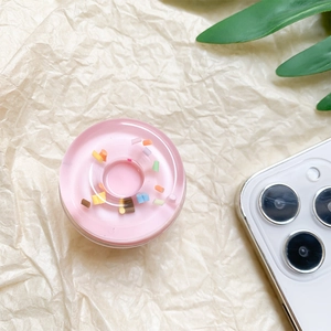 Detail of pink donut phone griptok with colorful sprinkles and transparent resin texture