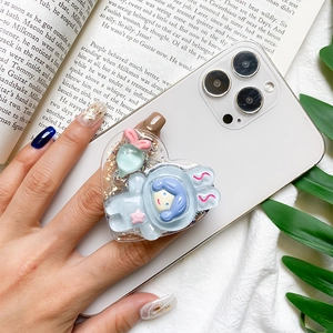 Detail of a 3D cartoon astronaut phone grip with purple hair and glitter epoxy finish
