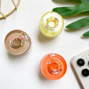 Close-up of donut-shaped phone grips in chocolate brown, yellow and orange colors