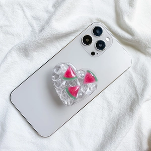Heart-shaped phone grip with resin ice cubes and red watermelon slices on white phone