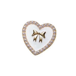 Elegant heart-shaped phone stand with white enamel, pearls, and gold bow detail