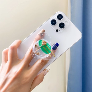 Detail of heart-shaped phone grip featuring green vintage rose and golden slogan