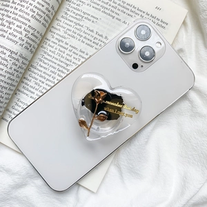 Heart-shaped phone grip with golden rose and ink pattern on transparent iPhone case