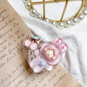 Close-up of pink heart resin phone stand with glitter and cute astronaut girl design