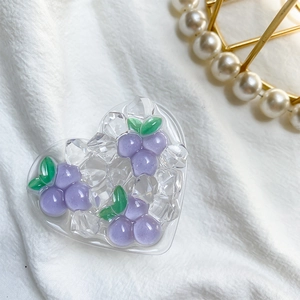 Detail view of heart-shaped grape ice cube phone grip with a fresh resin dessert style