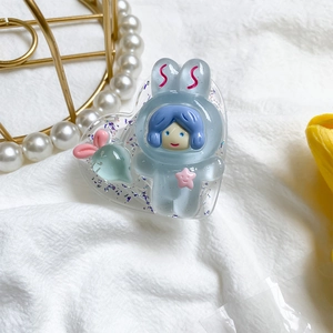 Macro detail of heart-shaped resin phone grip with glitter and cute cartoon bunny character