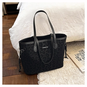 Detail of large leopard print tote bag with Creative Cat text and black leather straps